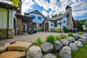 Rear view of house with a patio and a pergola