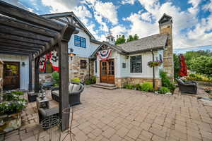 View of terrace featuring a pergola, an outdoor living space, and french doors