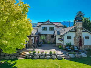 Back of house with a patio and a lawn