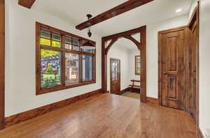 Foyer with beamed ceiling and hardwood / wood-style flooring