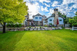 Back of house featuring a yard