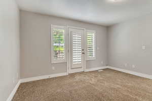 Primary bedroom with walkout to the backyard.