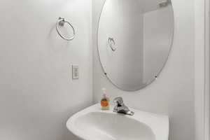 1/2 bathroom featuring a pedestal sink.