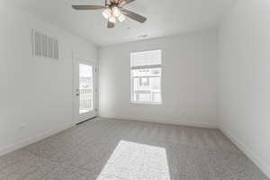 Empty room featuring ceiling fan and carpet floors