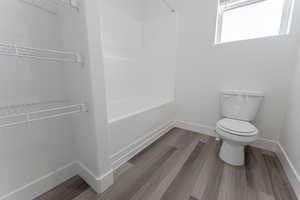 Bathroom with wood-type flooring and toilet