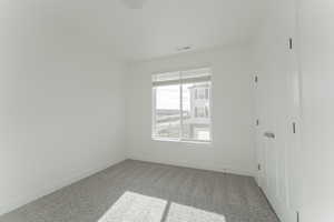 Unfurnished room with carpet floors