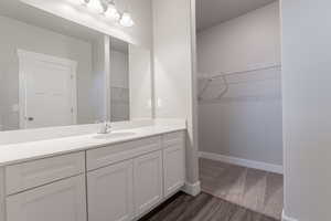 Bathroom featuring hardwood / wood-style floors and vanity