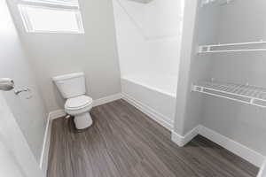 Bathroom featuring hardwood / wood-style floors and toilet