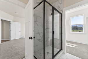 Bathroom with an enclosed shower, tile floors, and french doors