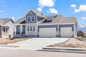 View of front of property featuring central AC, a garage, and a mountain view