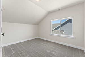 Bonus room featuring carpet and lofted ceiling