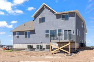 Rear view of house featuring central AC unit