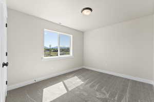 Unfurnished room featuring carpet flooring