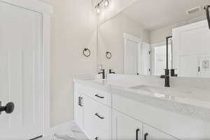 Bathroom with tile floors and double sink vanity