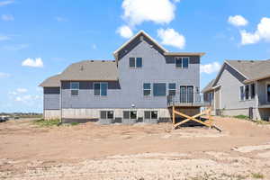 Back of house featuring central AC unit and a balcony