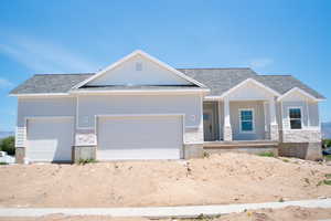 Craftsman-style home with a garage, a porch, stone siding, roof with shingles, and board and batten siding