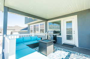 Exterior space featuring grilling area and an outdoor living space with a fire pit