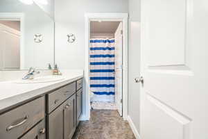 Bathroom featuring vanity, toilet, and tile patterned floors