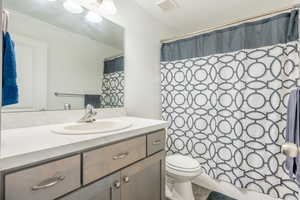 Bathroom with vanity, tile patterned flooring, and toilet