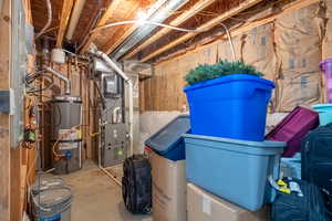 Storage room featuring strapped water heater