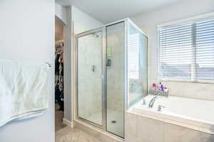 Bathroom featuring plus walk in shower and tile patterned flooring