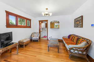 Sitting room featuring light hardwood / wood-style floors and a chandelier