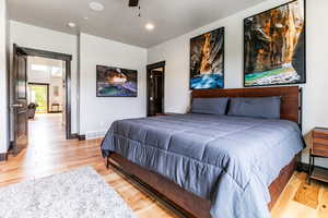 Bedroom with ceiling fan and light hardwood / wood-style flooring