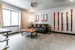 Living room featuring carpet and ceiling fan