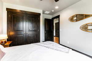 Bedroom featuring a closet, ceiling fan, and light hardwood / wood-style flooring