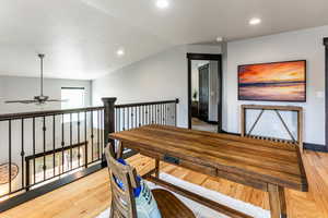 Interior space with ceiling fan, light hardwood / wood-style floors, and vaulted ceiling