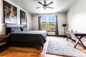 Bedroom with ceiling fan and light wood-type flooring