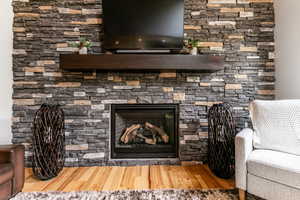 Room details with a fireplace and wood-type flooring