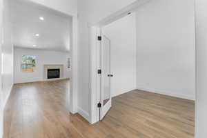 Interior space featuring vaulted ceiling and light hardwood / wood-style flooring