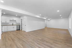 Unfurnished living room with a textured ceiling and light hardwood / wood-style floors