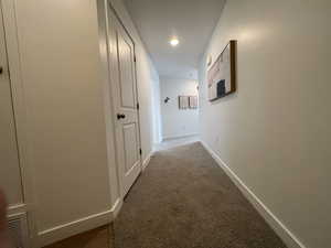 Hallway featuring carpet floors