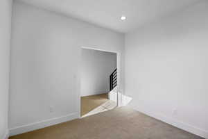 Unfurnished bedroom with light colored carpet