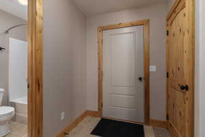 Doorway to outside with light tile flooring
