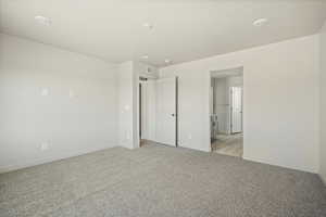 Unfurnished bedroom featuring light colored carpet