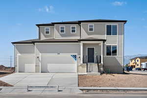 View of front of property featuring a garage and a mountain view