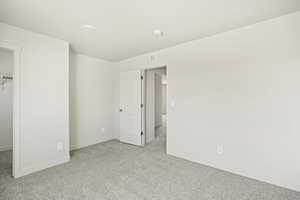 Unfurnished bedroom featuring light carpet