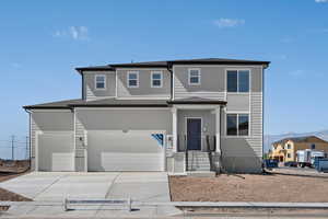 View of front facade featuring a garage and a mountain view