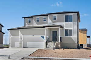 View of front facade featuring a garage