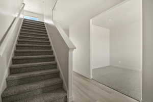 Stairway with hardwood / wood-style flooring