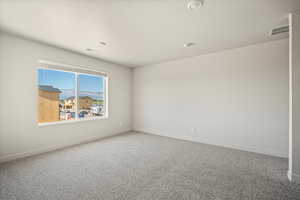 Unfurnished room featuring carpet and a textured ceiling