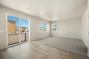 Empty room featuring light hardwood / wood-style flooring and plenty of natural light