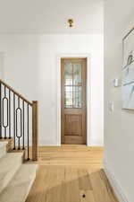 Entrance foyer featuring light wood-type flooring