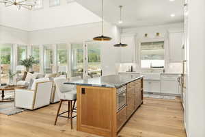 Kitchen featuring a center island, white cabinets, and plenty of natural light