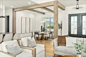 Living room with french doors, parquet floors, and a chandelier