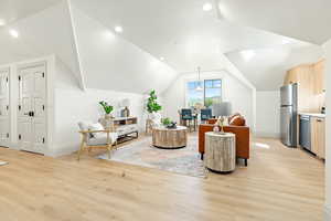 Accessory Apartment Living room featuring light hardwood / wood-style floors and vaulted ceiling