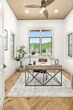 Office with wood ceiling, ceiling fan, and light parquet flooring